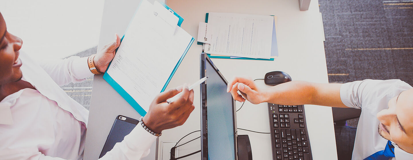 Two people at a work station