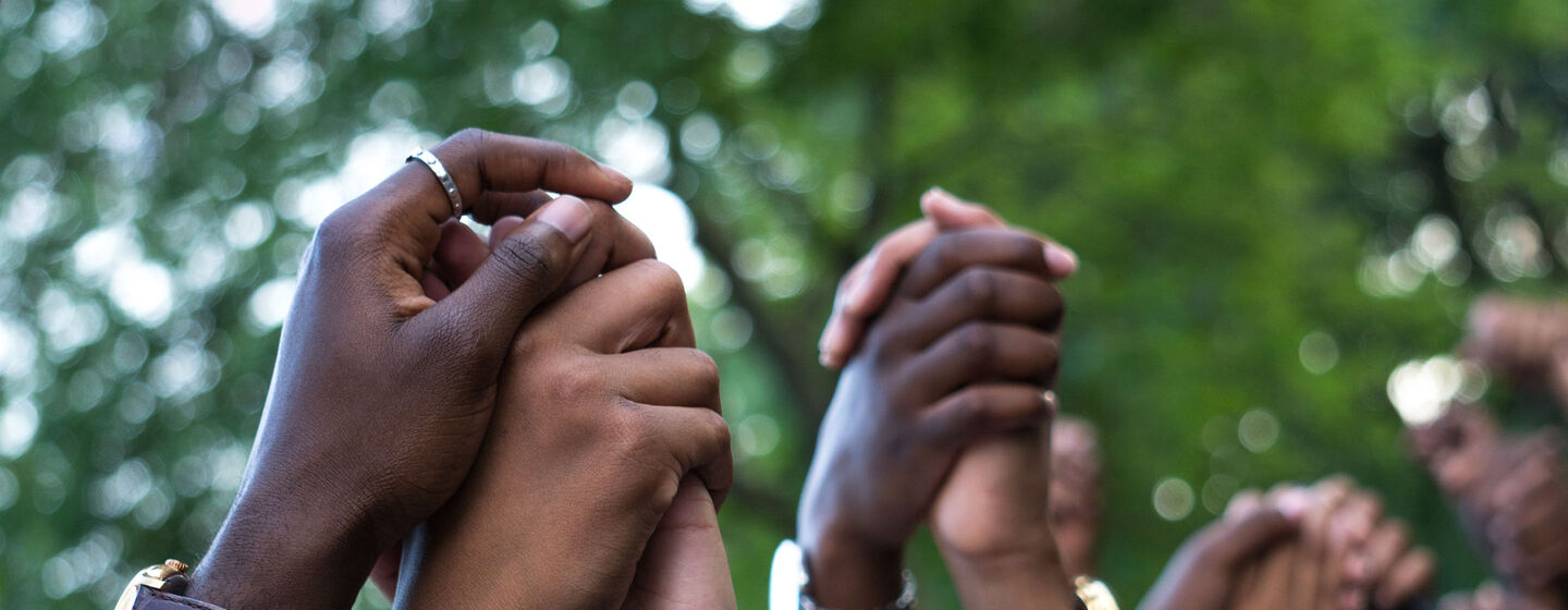 A group of people with their hands in the air.