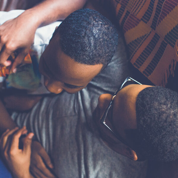 Two people hugging and cuddling on a couch